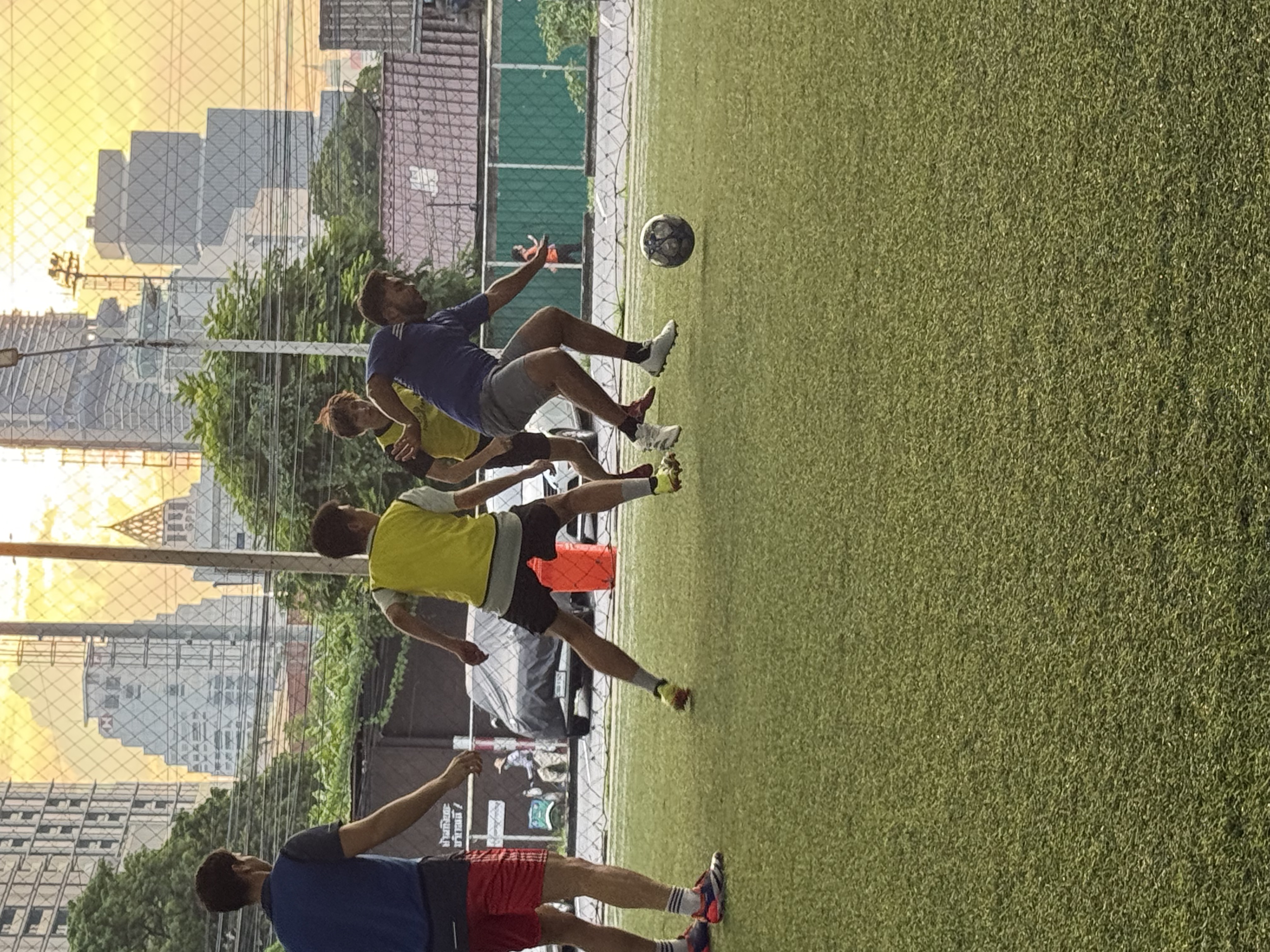Players during a pickup football game at POLO Football Park in Bangkok