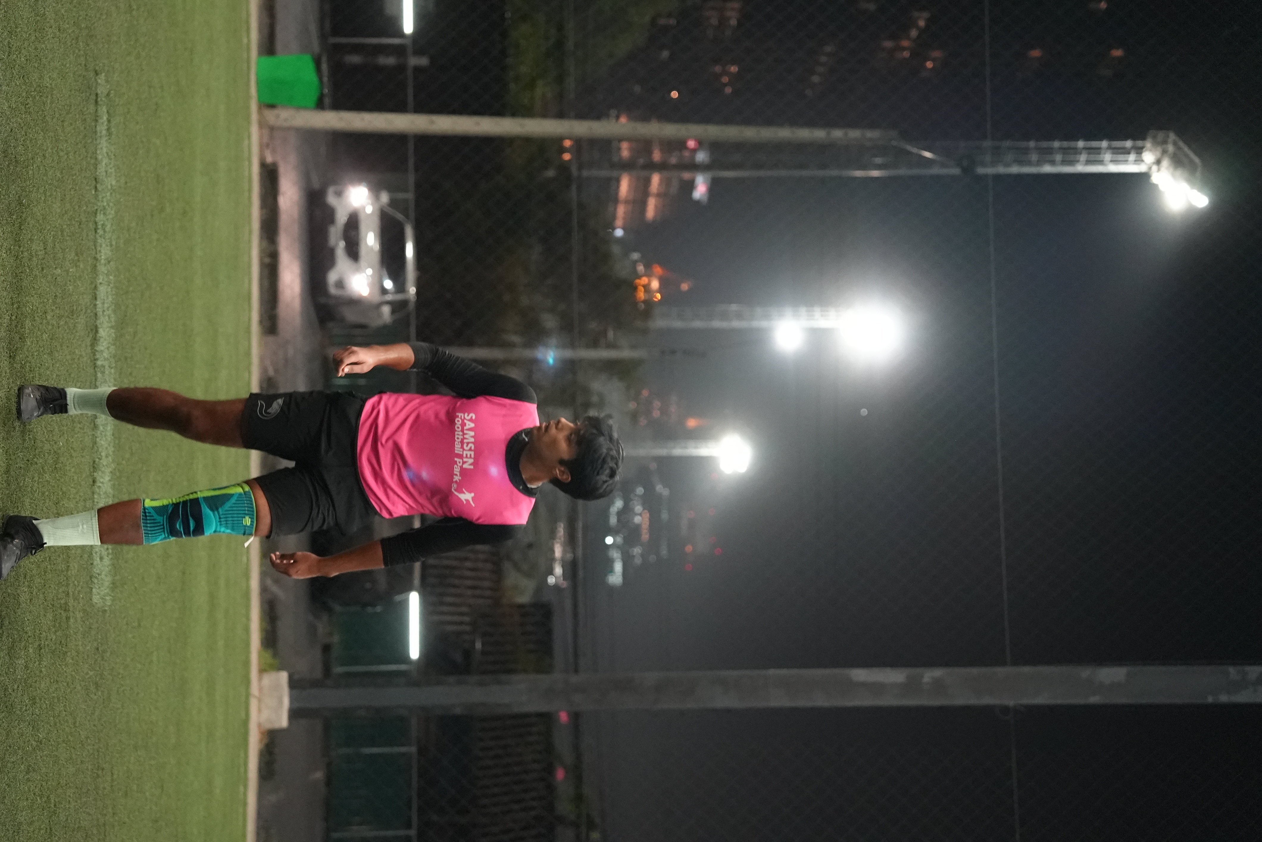 Evening pickup football game under floodlights at POLO Football Park near Phloen Chit BTS station in Bangkok