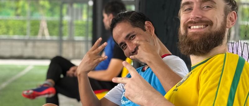 Expat players socializing after a pickup football game in Bangkok