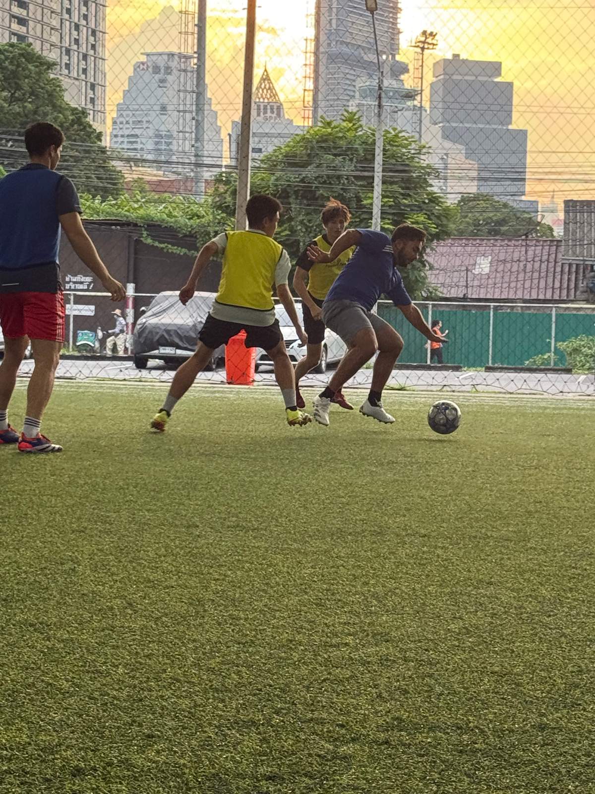 Players during a pickup football game at POLO Football Park in Bangkok