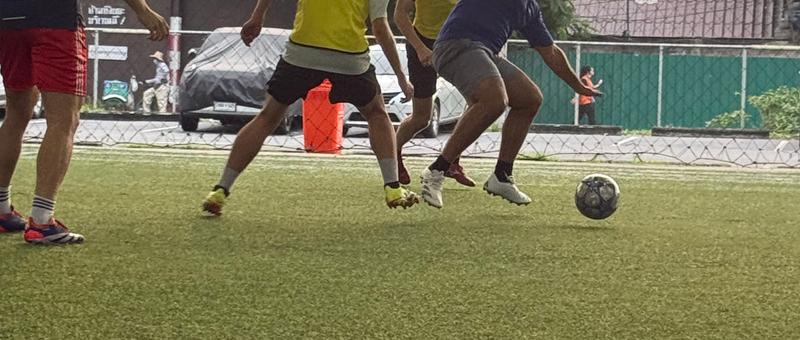Players during a pickup football game at POLO Football Park in Bangkok