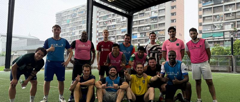 KickHub community group photo after a pickup football game in Bangkok