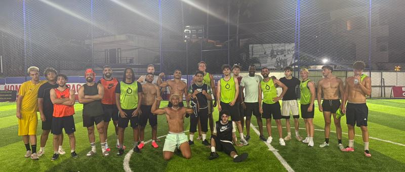 KickHub community group photo after a pickup football game in Bali
